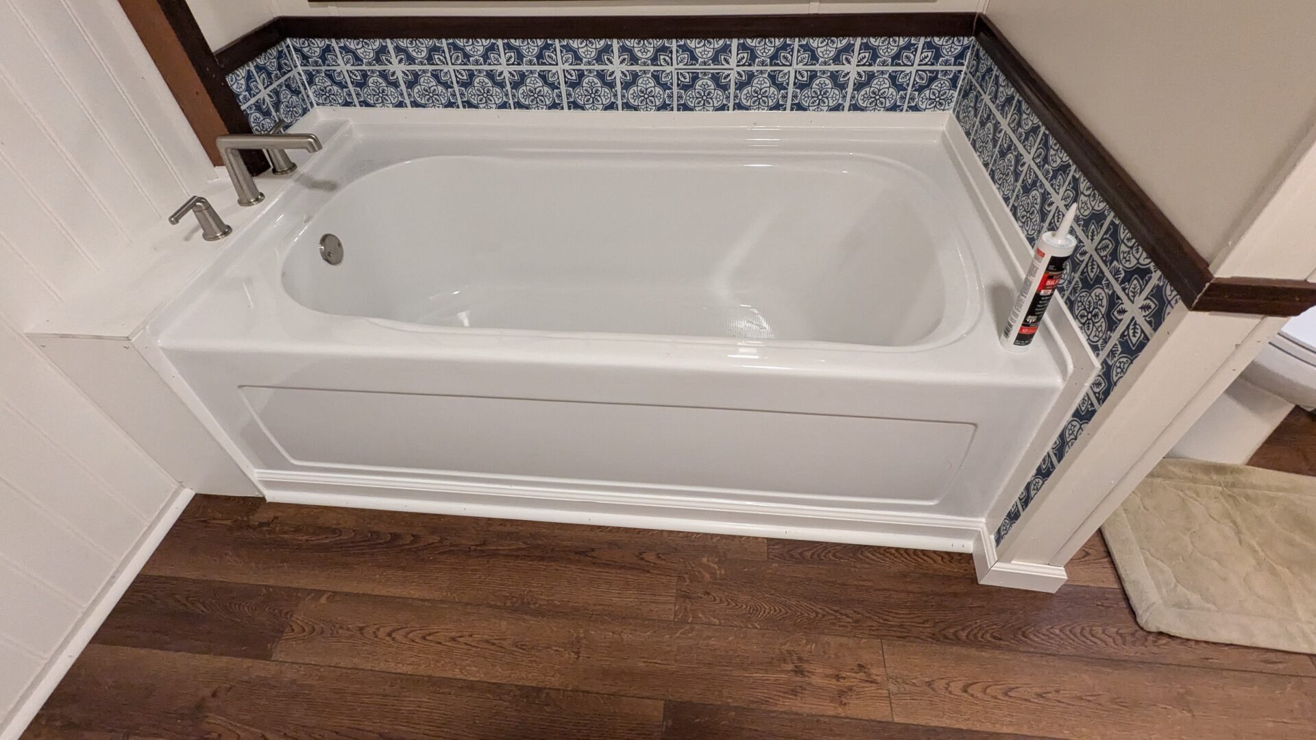 Modern bathtub on wooden floor